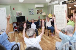 Residents sing while they exercise